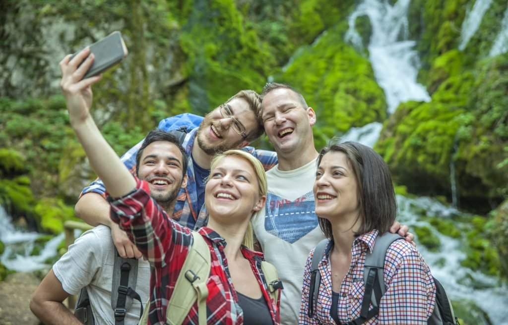 Family & Group Travel – Creating Memories Together group of friends having fun and taking selfies in nature